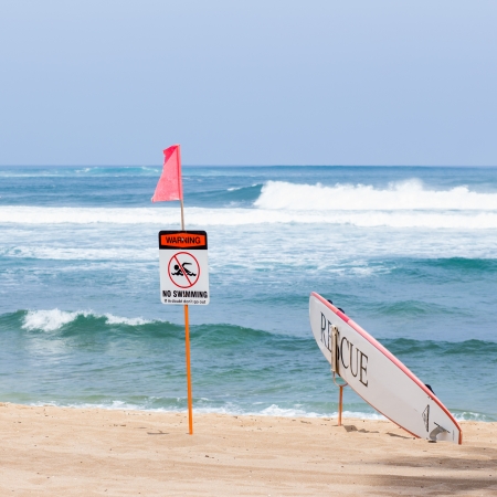 Warning no swimming sign with strong sea wave by the beach backgroundの写真素材