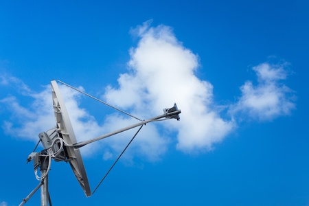 White satellite dish with blue skyの写真素材