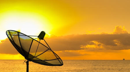 Side view of satellite dish with sunsetの写真素材