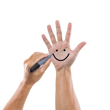 Draw smile on hand isolated on white backgroundの写真素材