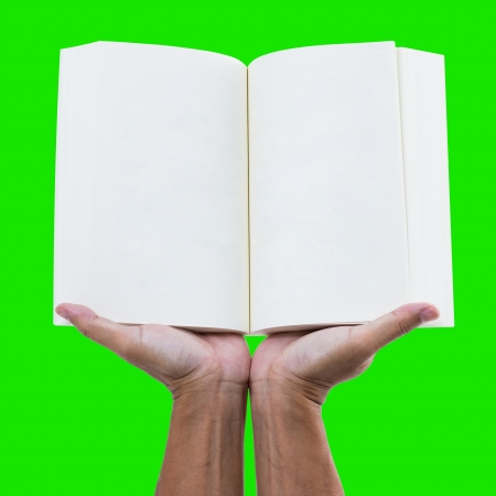 Hand holding blank notebook isolated on green backgroundの写真素材