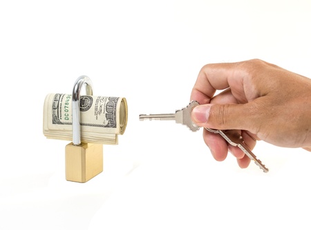 Bundle of 100 Dollar with key lock isolated on white backgroundの写真素材