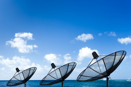 Satellite dish with ocean の写真素材