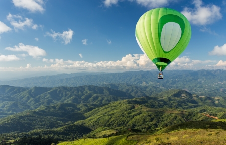 Hot air balloon over the mountainの写真素材