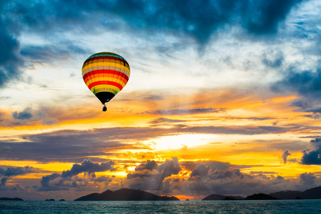 Hot air balloon over the sea at Sunsetの写真素材