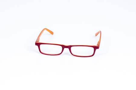 Orange reading eyeglasses on white backgroundの写真素材