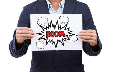 Business man hand holding paper with boom speech bubble isolated on white background
