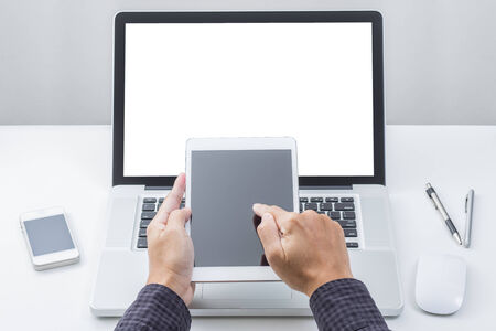 Man hands touching tablet computer with laptop background