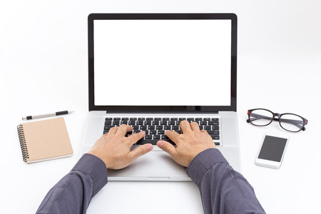 Man hand typing on laptop keyboard with blank screen monitorの写真素材