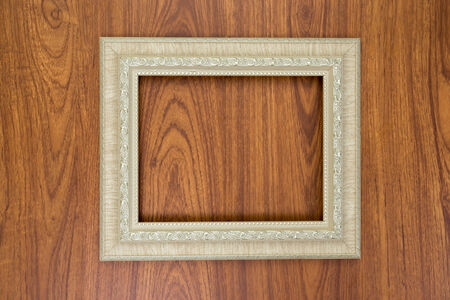 Ivory frame on brown wood backgroundの写真素材