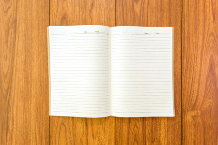 Blank notebook on wood background