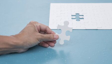 Man hand holding jigsaw puzzle