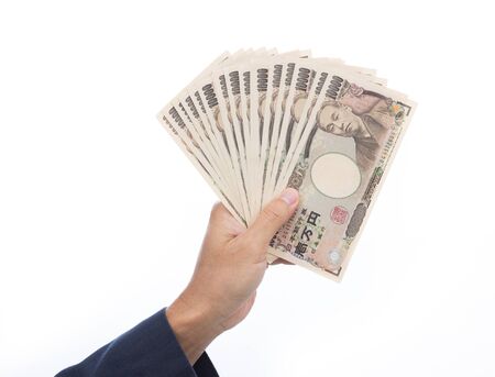 Businessman hand holding Japanese Yenの写真素材