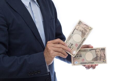 Businessman hand holding Japanese Yenの写真素材
