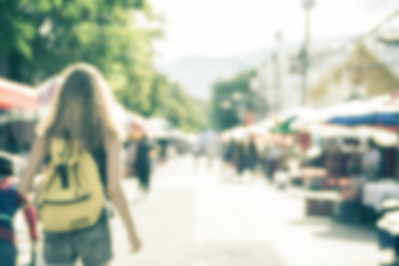 Blurred image of people shopping at street market use for background, retro tone color filtered