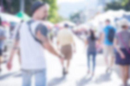 Blurred image of people walking around street market use for backgroundの写真素材
