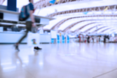 People traveling at airport terminal in blurred motion with retro color effectedの写真素材