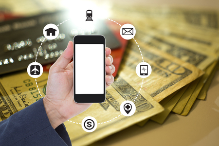 Mockup copyspace hands holding mobile phone with financial concept backgroundの写真素材