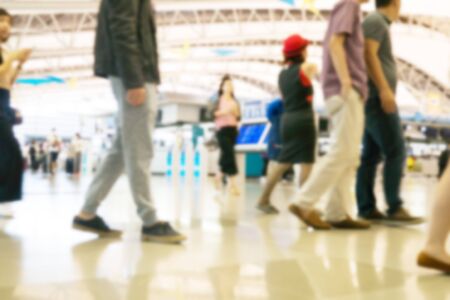 People traveling at airport terminal in blurred motion with retro color effected, Abstract blur people backgroundの写真素材