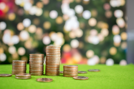 Stack of coins on green and christmas backgroundの写真素材