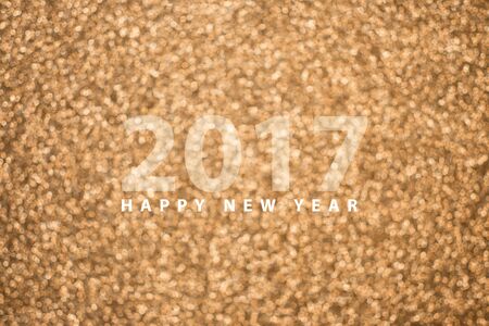 Happy new year 2017 on festive gold blur bokeh background