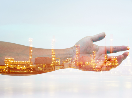 Double exposure of man hand and industrial building の写真素材