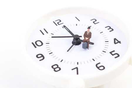 Man sitting on the clock at five o'clockの写真素材