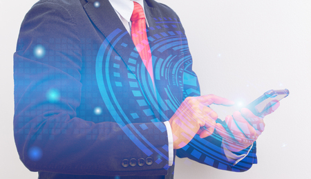Double exposure of Unrecognizable Businessman hand holding smartphone with digital technology graphicの写真素材
