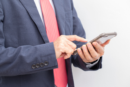 Unrecognizable Businessman hand holding smartphoneの写真素材