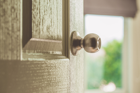 Door open with light from window and vintage color effectedの写真素材