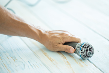 Man hand holding microphone with vintage color effectedの写真素材