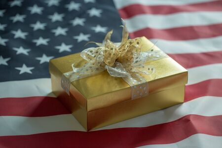 Gold gift box on american flagの写真素材