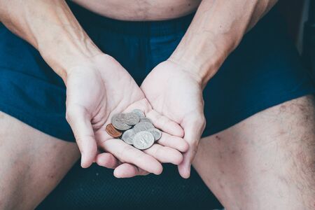 Close up of poor man hand with small money