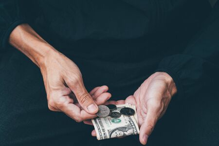 Close up of poor man hand with small moneyの写真素材