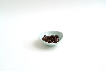 Black vitamin pills on white backgroundの写真素材