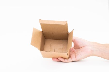 Man hand holding brown paper box on white background