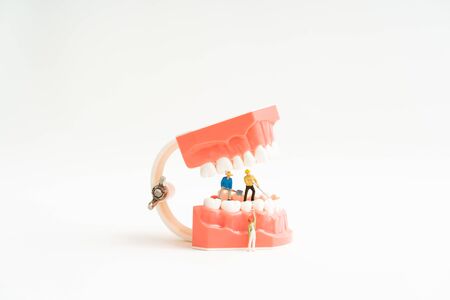 miniature worker and tooth dental model. Dental care conceptの写真素材