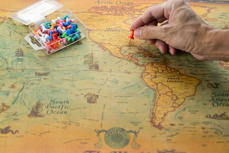 Man hand pin pointing on United States of America map