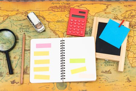 Blank notebook with accessory on world map. travel business concept