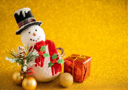 Christmas decoration snowman on gold glitter backgroundの写真素材