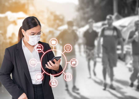 Asian women wearing surgical face mask and checking expenses on mobile application