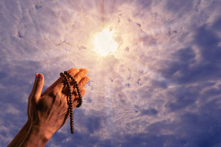 Man hand with beads praying god.の写真素材