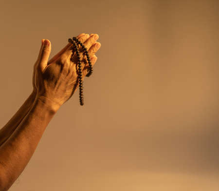 Man hand holding bible and bead. Religion conceptの写真素材