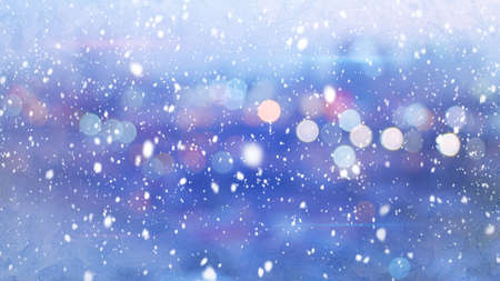snowfall and defocused lights evening wintry cityの写真素材
