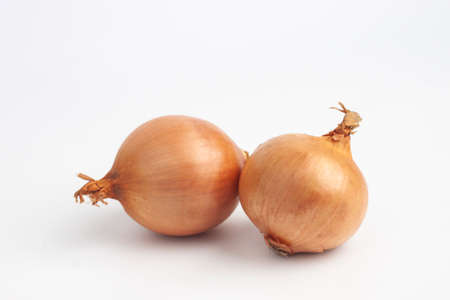 brown onions isolated on white backgroundの写真素材