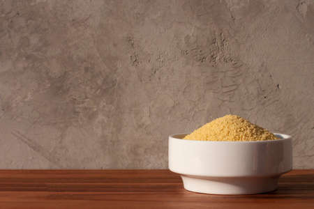 dried cous-cous pasta on wooden tableの写真素材