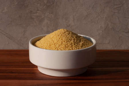 dried cous-cous pasta on wooden tableの写真素材