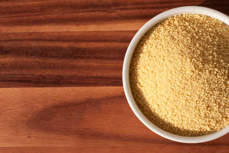 dried cous-cous pasta on wooden tableの写真素材