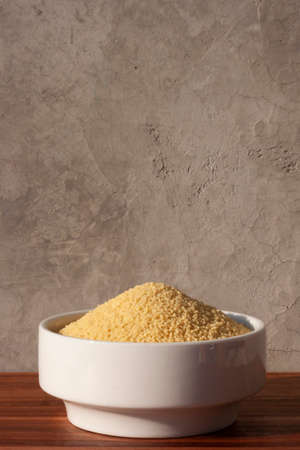 dried cous-cous pasta on wooden tableの写真素材