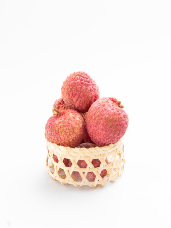 Fresh lychee in bamboo basket on white background - Healthy food styleの写真素材